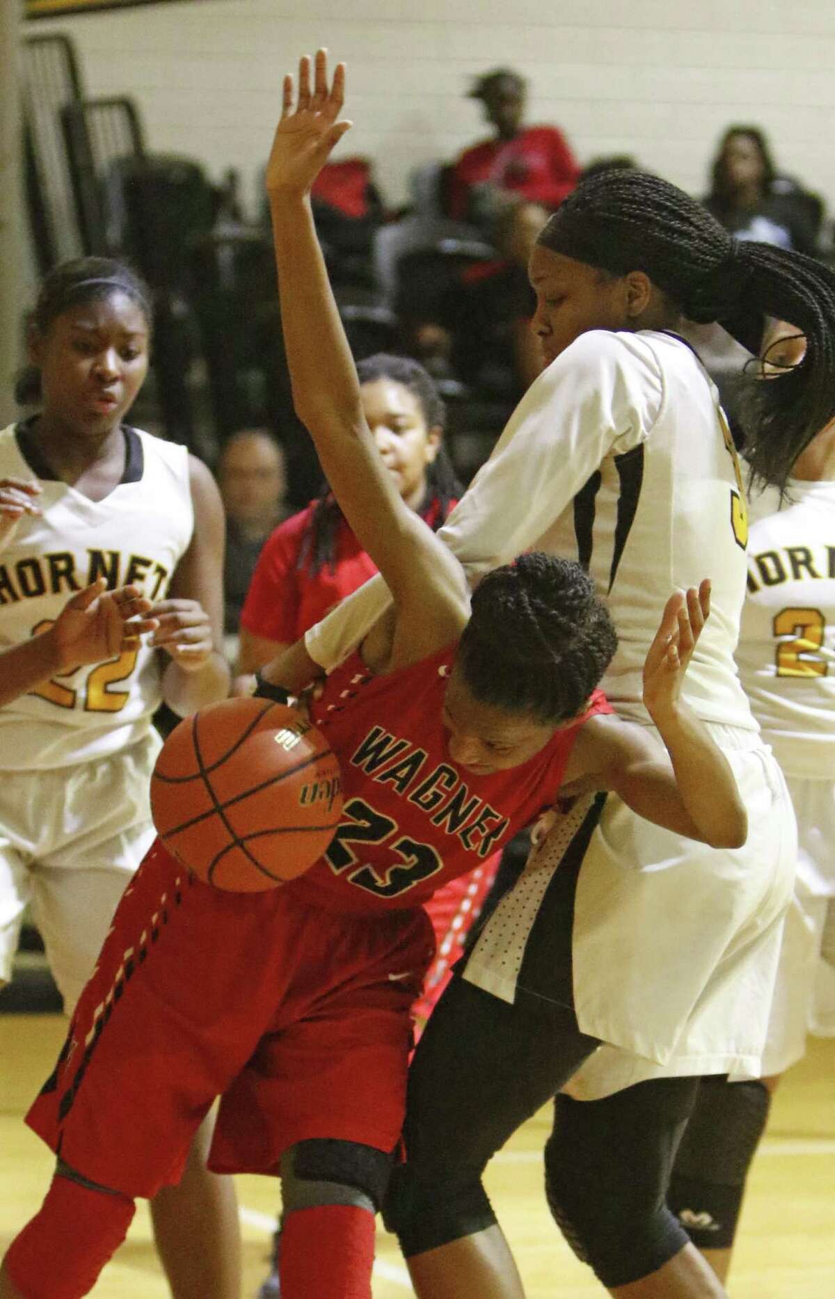 Wagner?•s Kiana Williams is fouled by East Central?•s NaLyssa Smith from the District 27-6A girls high school basketball game between Wagner at East Central on Tuesday, December 21, 2016