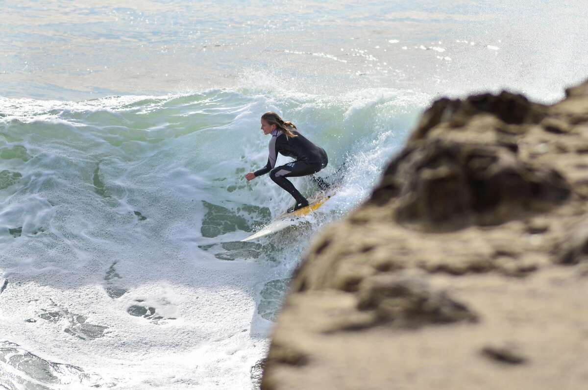 Savannah Shaughnessy catchs a wave at Steamer Lane near the Mark Abbot Memorial Lighthouse in Santa Cruz, Calif., on Monday, Nov. 19th, 2012.