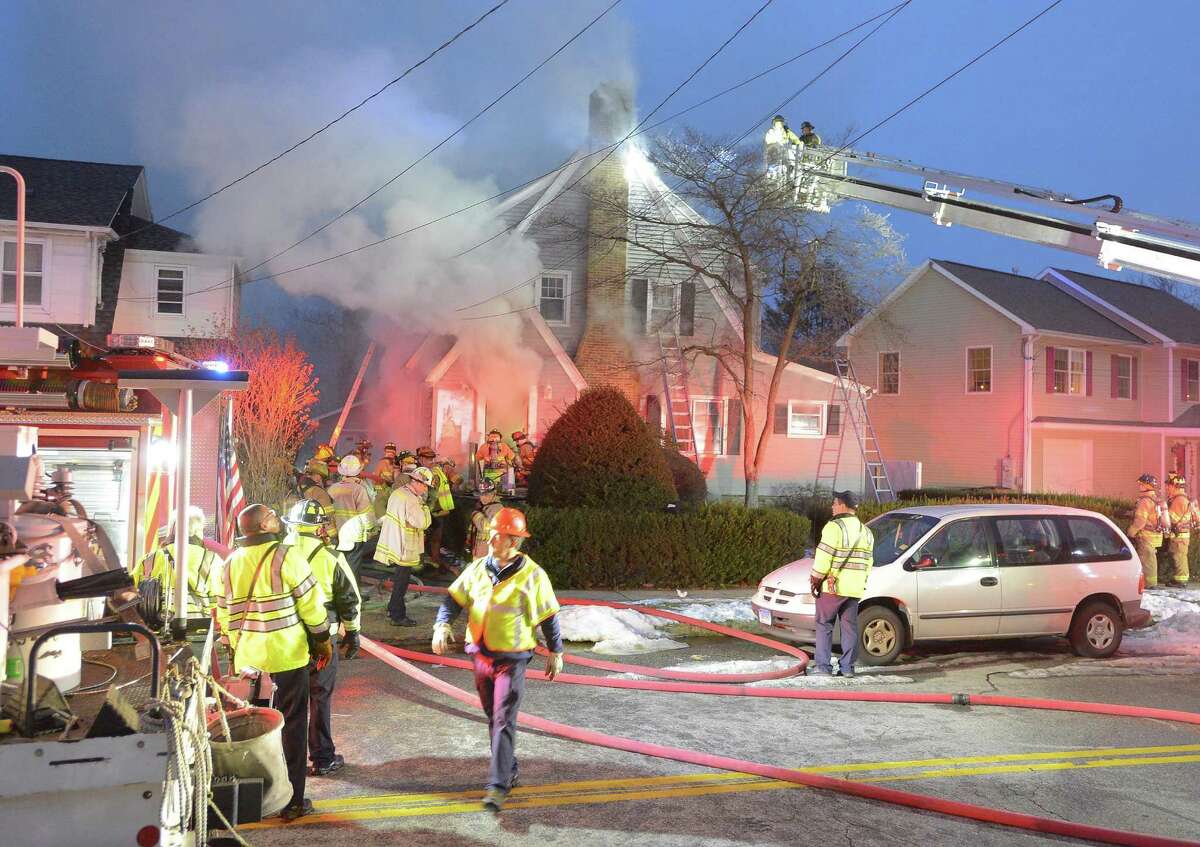 Stamford fire displaces family, injures two