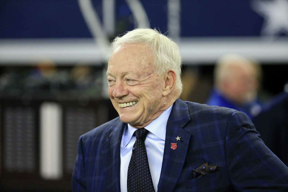 Dallas Cowboys team owner Jerry Jones smiles as he walks onto the field during warm-ups before the game against the Tampa Bay Buccaneers on Dec. 18, 2016, in Arlington.