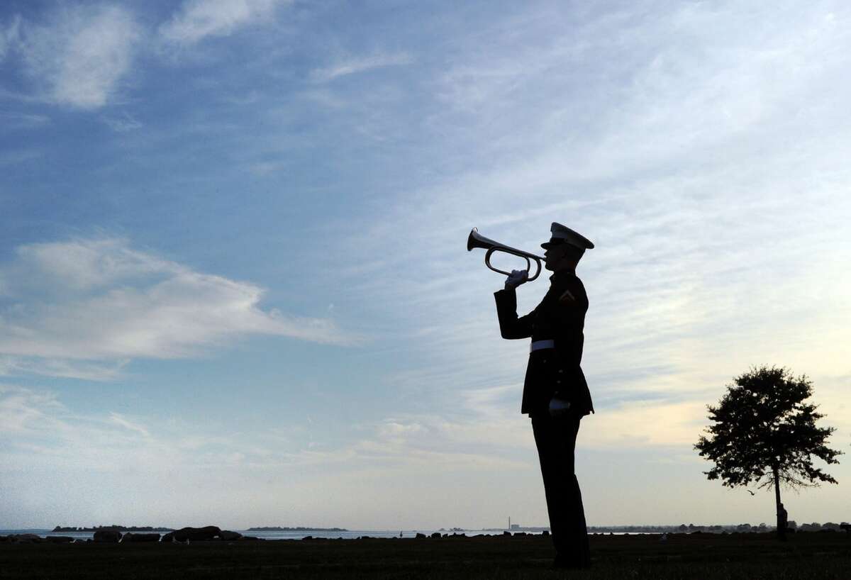 Lance Corporal Brian Drury of the U.S. Marine Corps, a Stratford resident, plays Taps during the 15th annual 9/11 Memorial Ceremony, honoring and celebrating the lives of those killed in the September 11, 2001 terrorist attacks at the 9/11 Memorial in Sherwood Island State Park in Westport,Conn., Thursday, Sept. 8, 2016.