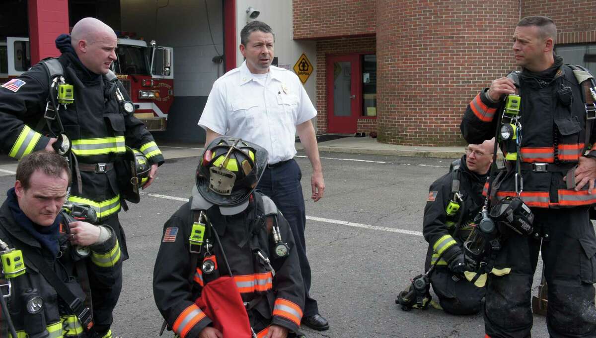 Westport Fire Chief Andrew Kingsbury, center, debriefs firefighters following a training exercise at fire department headquarters in May 2011.