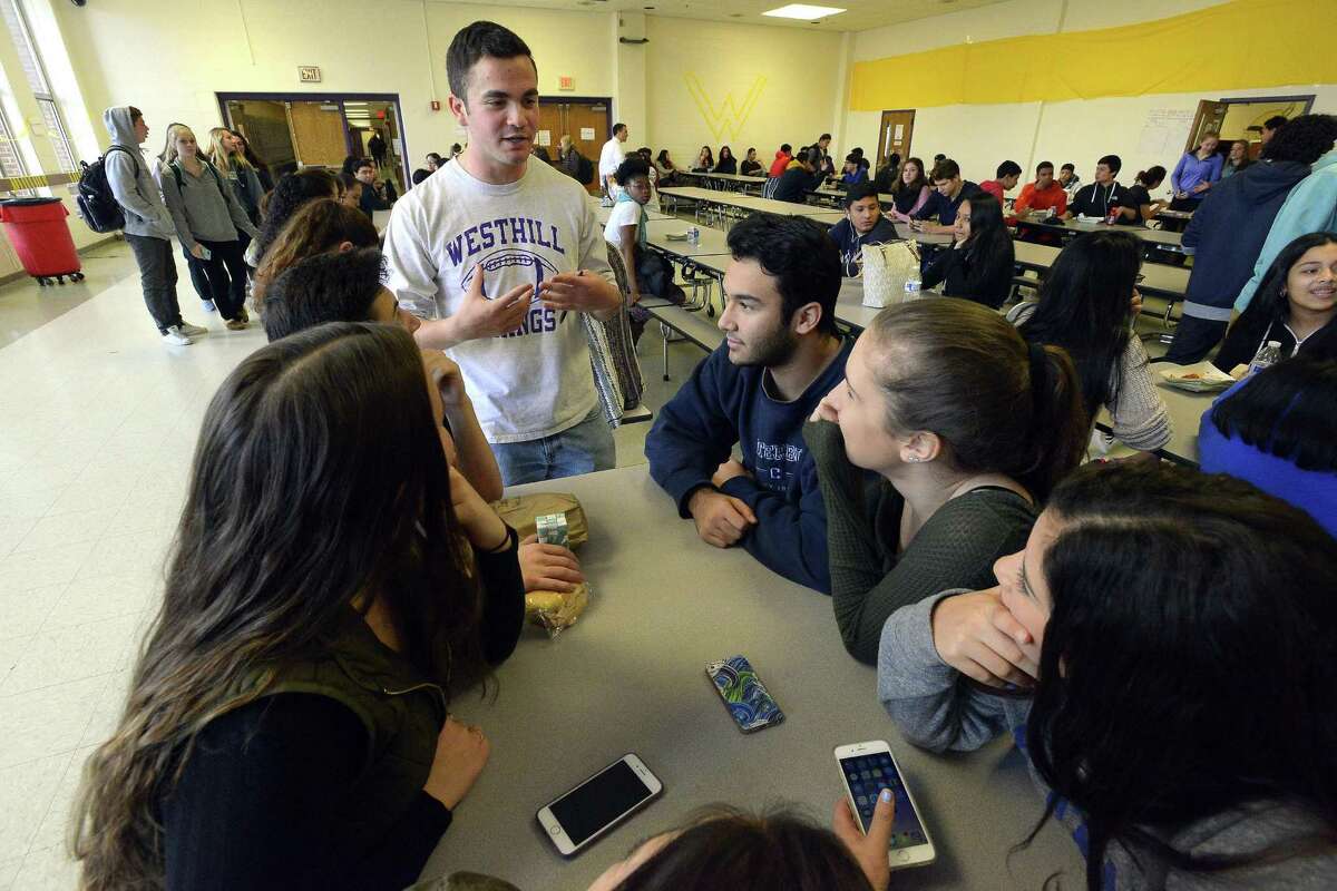Noah Klein, Student Ombudsman for Westhill High School student newspaper Westword chats with students during lunch.