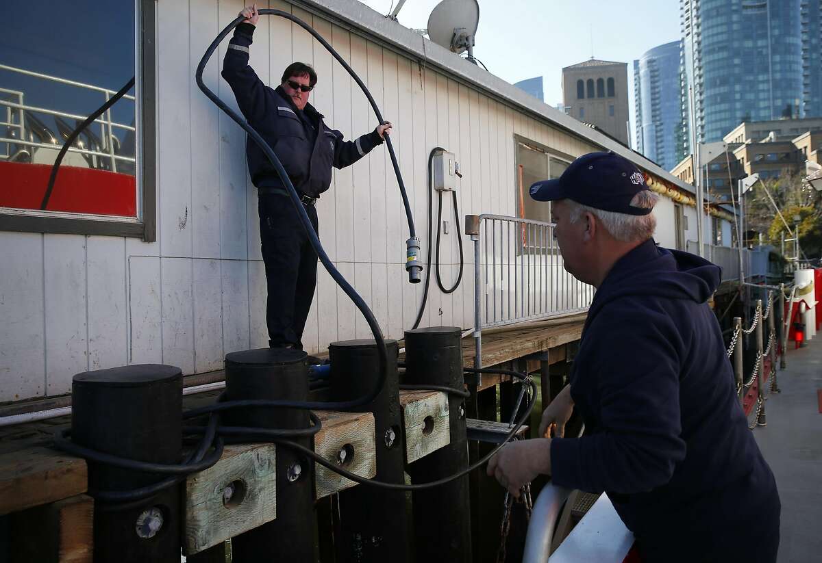 Lt. Raul Francisco, left, helps Engineer Mike Shaw ready the St. Francis fireboat for a short trip for the San Francisco Chronicle to photograph the pier at Fire Station 35 at Pier 22 1/2 Dec. 22, 2016 in San Francisco, Calif.