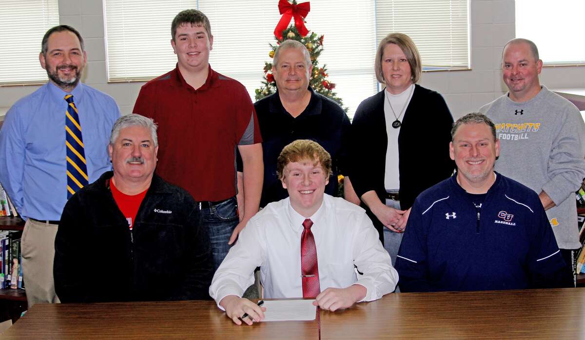   Bad Axe’s Brandon Erla inked his letter of intent to Cleary University earlier this week. Joining Erla at the signing were, front from left, Bad Axe varsity head coach Bob Breault and Cleary University head coach Karl Kling. Back row, from left, Bad Axe varsity assistant coach Brad Roth, brother Michael Erla, dad Bob Erla, mom Dawn Erla and Bad Axe junior varsity coach Ron Johnston. 