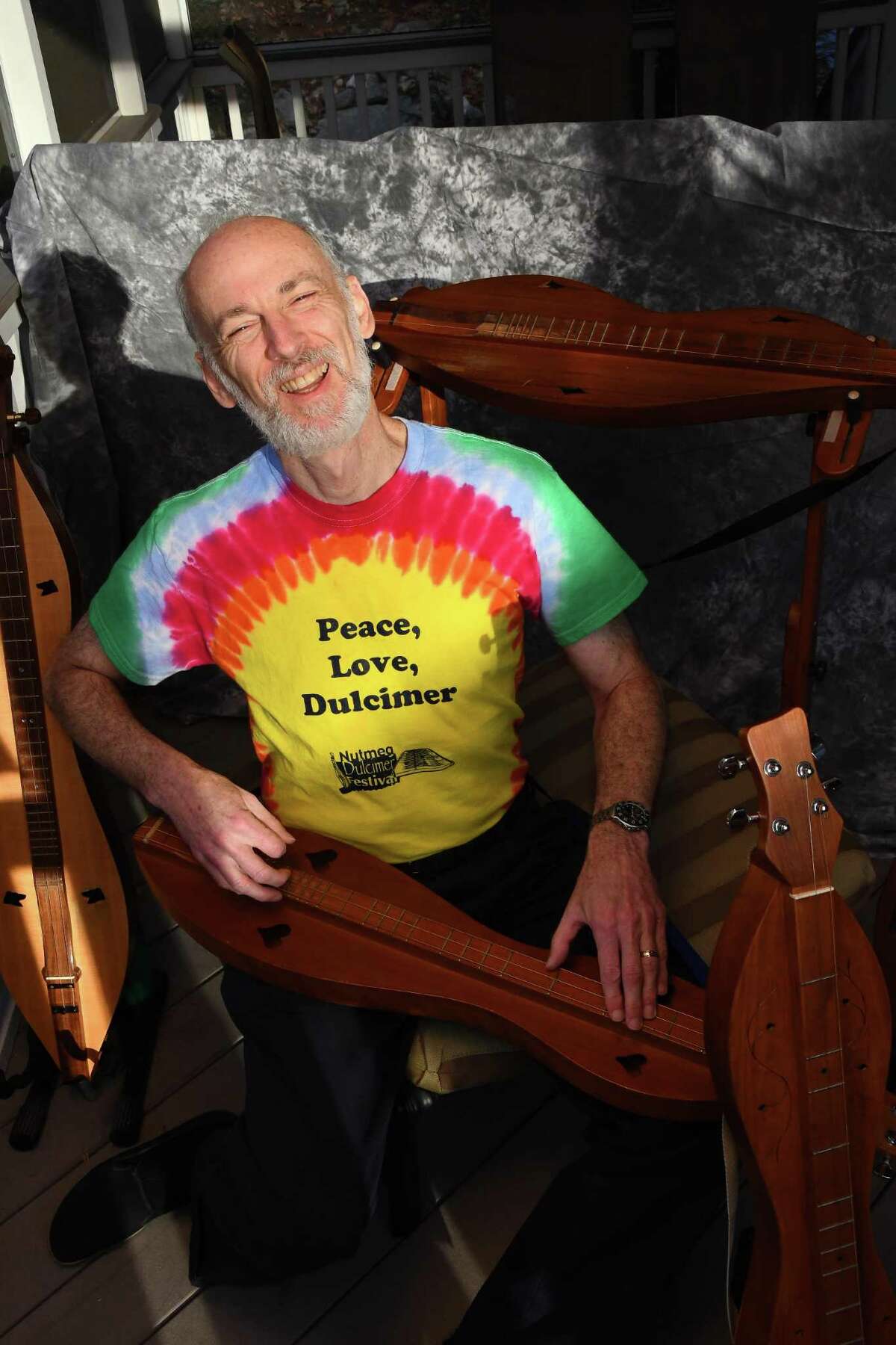 Wearing one of his favorite shirts, Sam Edelston sings and plays one of his many dulcimers.