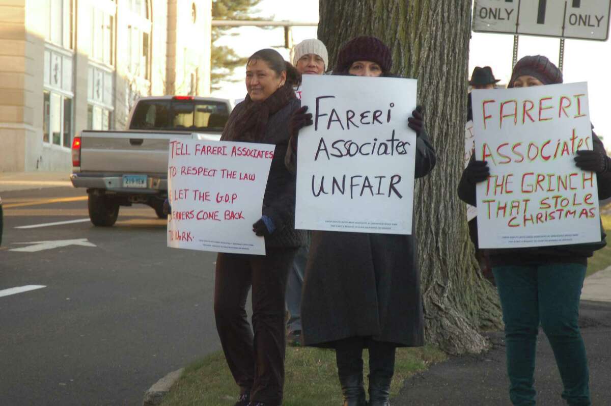 Elidel Garfias, left, Rosalia Bravo and Sonia Osorio, office cleaners at Greenwich Office Park who were fired after Greenwich-based Fareri Associates took over the property last month, protest Thursday outside the company's office on Dearfield Drive.