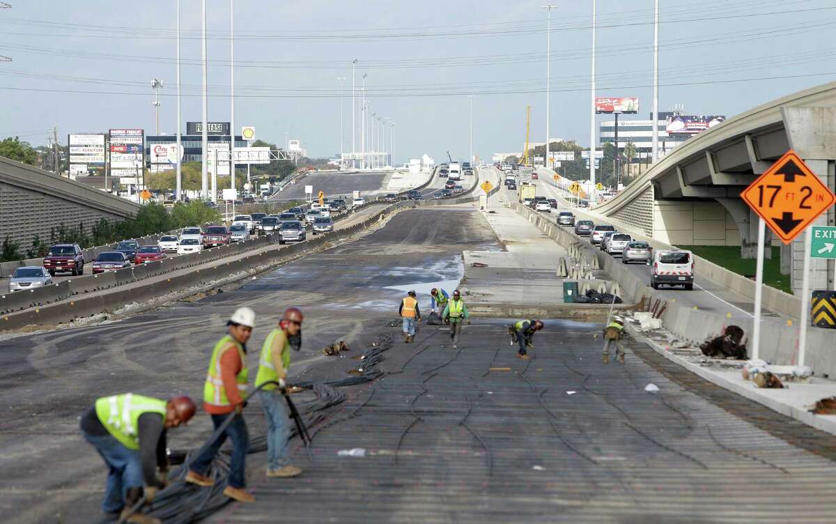 Workers prepare the 290 westbound main lane pavement near Loop 610, shown Dec. 13.