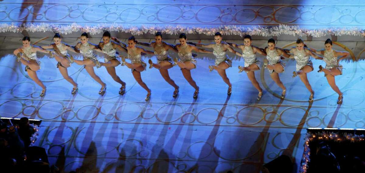 FILE - In this Wednesday, Dec. 4, 2013, file photo, the Rockettes perform before the lighting of the Rockefeller Center Christmas tree in New York. The Radio City Rockettes have been assigned to dance at President-elect Donald TrumpÂ?’s inauguration January 2017. (AP Photo/Kathy Willens, File)