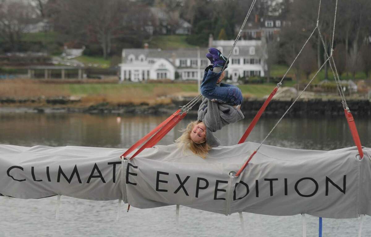 Alegra Schwörer, 5, hangs on the ropes docking her family's 50-foot sailboat at Indian Harbor Yacht Club in Greenwich, Conn. Thursday, Dec. 22, 2016. Climatologist Dario Schwörer, his wife Sabine and their five children are the leaders of the TOPtoTOP Global Climate Expedition, which has circumnavigated the globe conducting field-based research, visiting remote regions and sharing solutions to protect and preserve the planet from climate change. The family is making a two-week stop in Greenwich to speak to locals about their mission before heading off to sea again after the New Year.