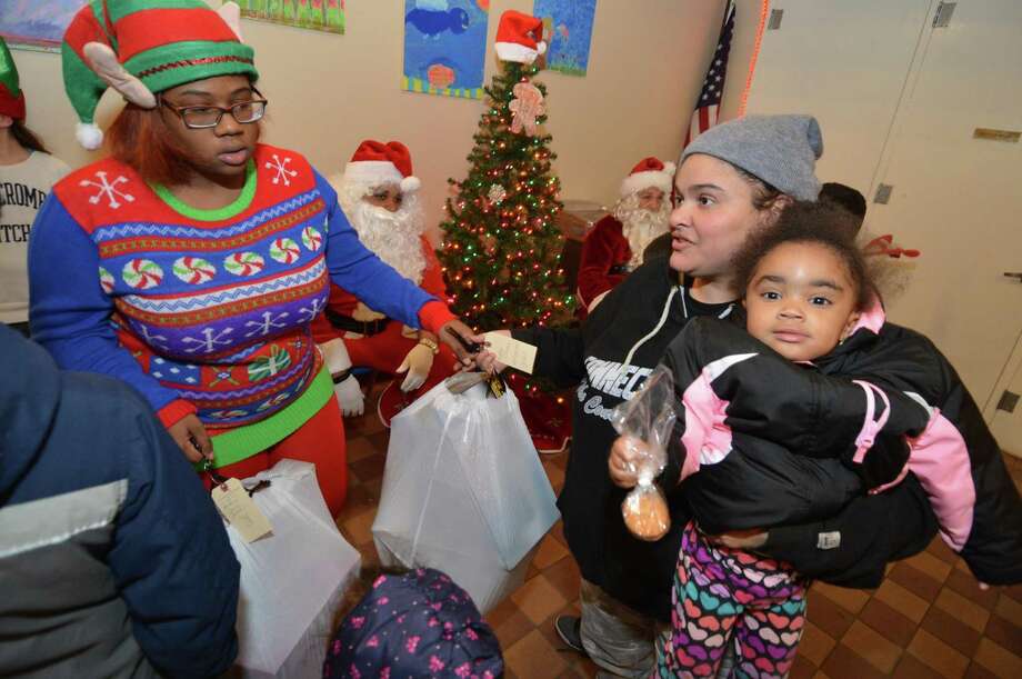 luceli rivera is given a bag of toys and gifts for her family from elf - Free Christmas Trees For Low Income Families luceli rivera is given a bag of toys and gifts for her family from elf - Free Christmas Trees For Low Income Families