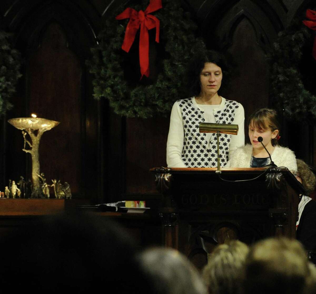With her mother Celeste Frye-Lintern at her side, Tallulah Lintern, 10, of Stamford recites a reading as part of a Christmas Eve service. The Unitarian Universalist Congregation in Stamford holds "Fear Not Good News, Great Joy, For All People," a "Christmas Eve Carol" and candlelight service in Stamford on Dec.24, 2016.