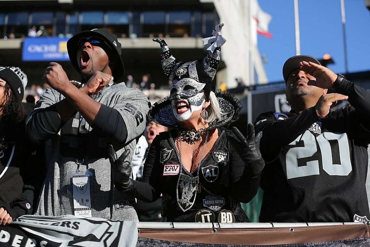 Oakland Raiders fans cheer during an NFL game against the Los