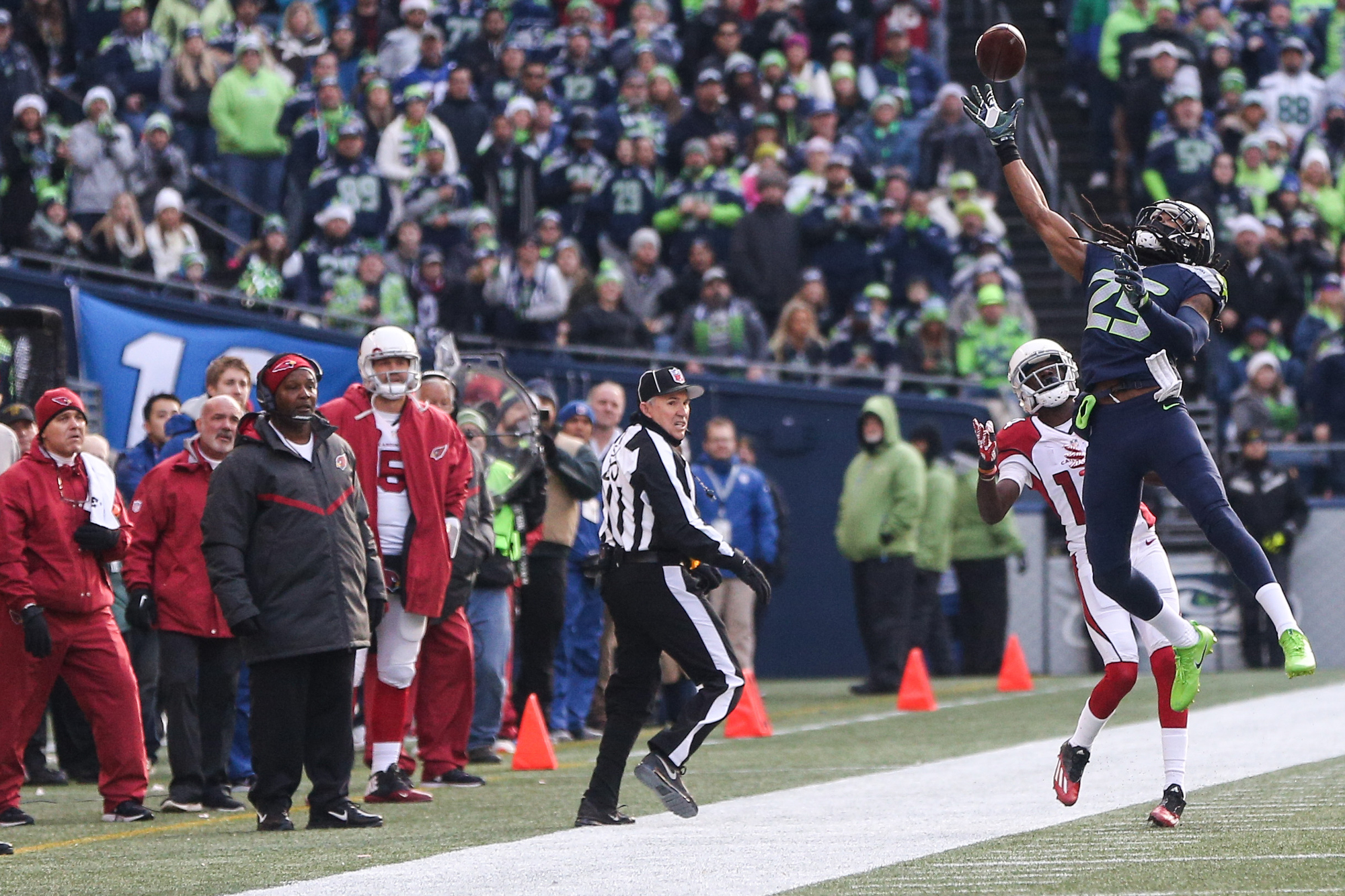 Seattle Seahawks quarterback Russell Wilson stiff arms Tampa Bay Buccaneers  cornerback Michael Adams (21) on his way to a first down in the third  quarter at CenturyLink Field in Seattle, Washington on