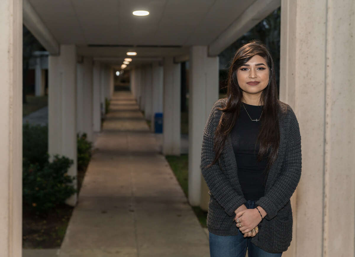 Dania Amezquita, 19, stands near a walkway at San Jacinto College in Pasadena, where she is a student. Amezquita represents the next wave of Hispanic voters who could turn Texas into a battleground state.