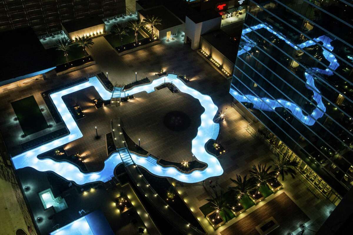 The Texas-shaped lazy river pool is lit up during the grand lighting ceremony at the Marriott Marquis hotel on Monday, Dec. 26, 2016, in Houston.