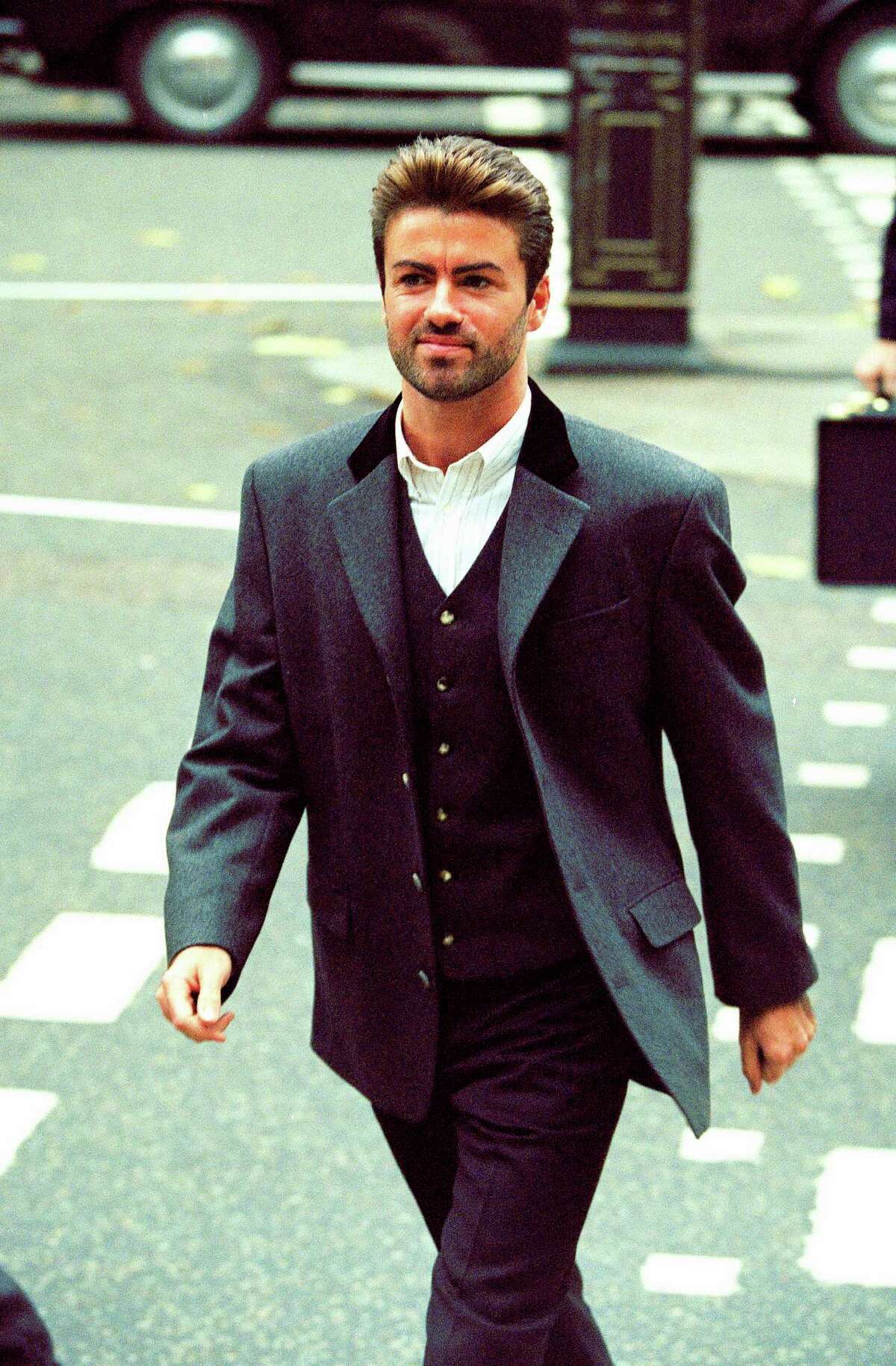 FILE - In this Oct. 28, 1993, file photo, pop star George Michael arrives to give evidence at the Royal Courts of Justice in London. Michael was petitioning the court to release him from his contract with Sony Music Entertainment (UK) Ltd. Michael, who rocketed to stardom with WHAM! and went on to enjoy a long and celebrated solo career lined with controversies, has died, his publicist said Sunday, Dec. 25, 2016. He was 53. (AP Photo/Alistair Grant) ORG XMIT: NYGM106