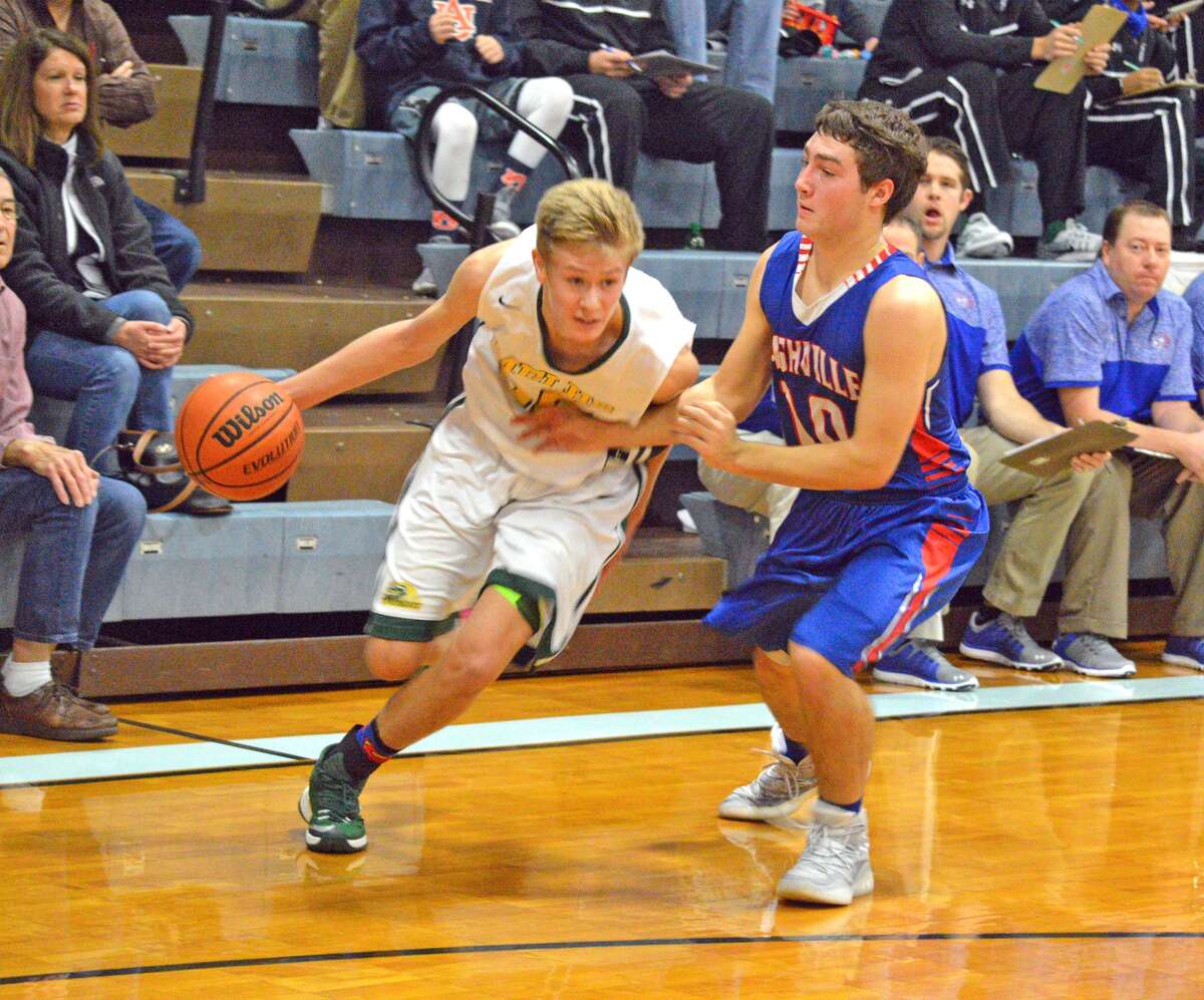 Metro-East Lutheran senior Noah Coddington, left, tries to dribble past Nashville’s Hayden Heggemeier during Tuesday’s opening game at the Mater Dei Holiday Tournament.