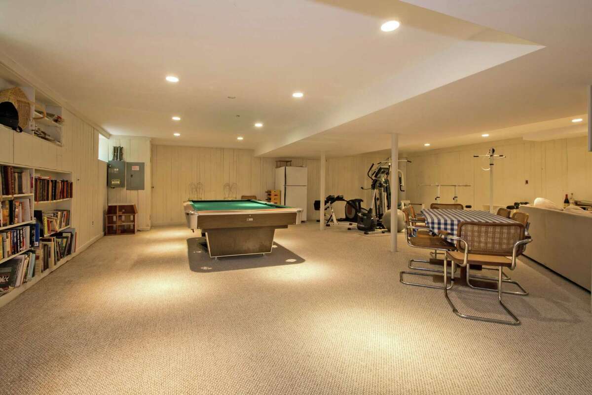 The full, partially finished basement offers a lot of space and flexible use of that space including as a media room, playroom, exercise area, and craft room with built-in bookshelves.
