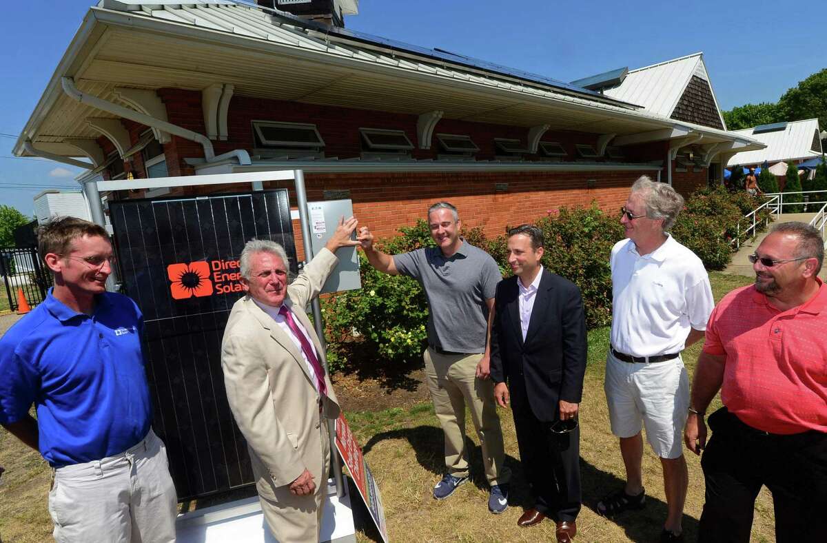 Local dignitaries and Direct Energy Solar staff including Direct Energy Solar project lead, Brett Avelin, Norwalk Mayor, Harry Rilling, The Mayor's Energy and Environment Task Force Chairman, John Kydes, State Senate Majority Leader, Bob Duff, Councilman Tom Livingston, and Norwalk Recreation and Parks Director, Mike Mocciae, present the new solar panels on the bath houses at Calf Pasture Beach in Norwalk, Conn. during a press conference there Wednesday, July 6, 2016.