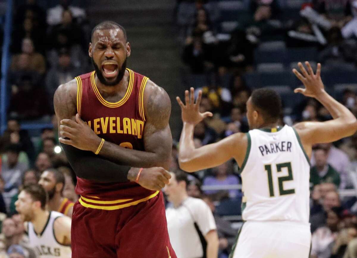 FILE - In this Nov. 29, 2016 file photo, Cleveland Cavaliers' LeBron James reacts to no call being called on his shot during the second half of an NBA basketball game against the Milwaukee Bucks in Milwaukee. On Tuesday, Dec. 27, James, who ended 52 years of sports heartache by bringing Cleveland a championship and used his superstar platform to address social causes, was chosen as The Associated Press 2016 Male Athlete of the Year. (AP Photo/Morry Gash, File)
