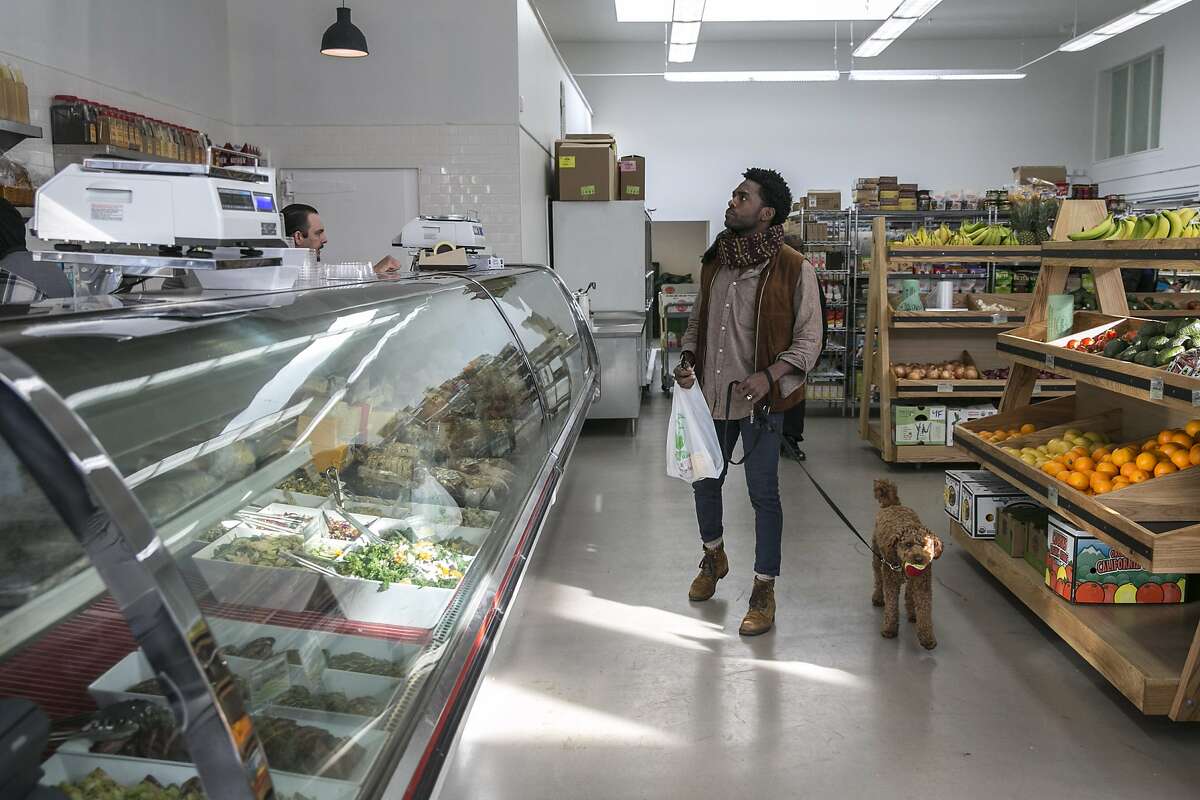 Lowell Caulder checks out the deli with his dog Moses at Luke's Local on Tuesday, Dec. 27, 2016 in San Francisco, Calif.
