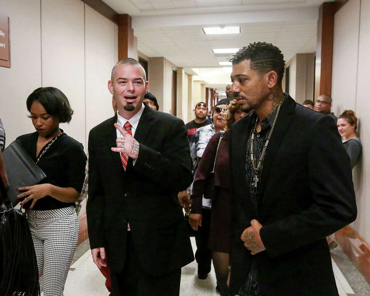 Paul Slayton, center, better known as Houston rapper Paul Wall, enters the 262nd Criminal Court at the Harris County Criminal Justice Center on Tuesday. Slayton, 35, was arrested last week with nine other people at a Heights-area smoke shop.