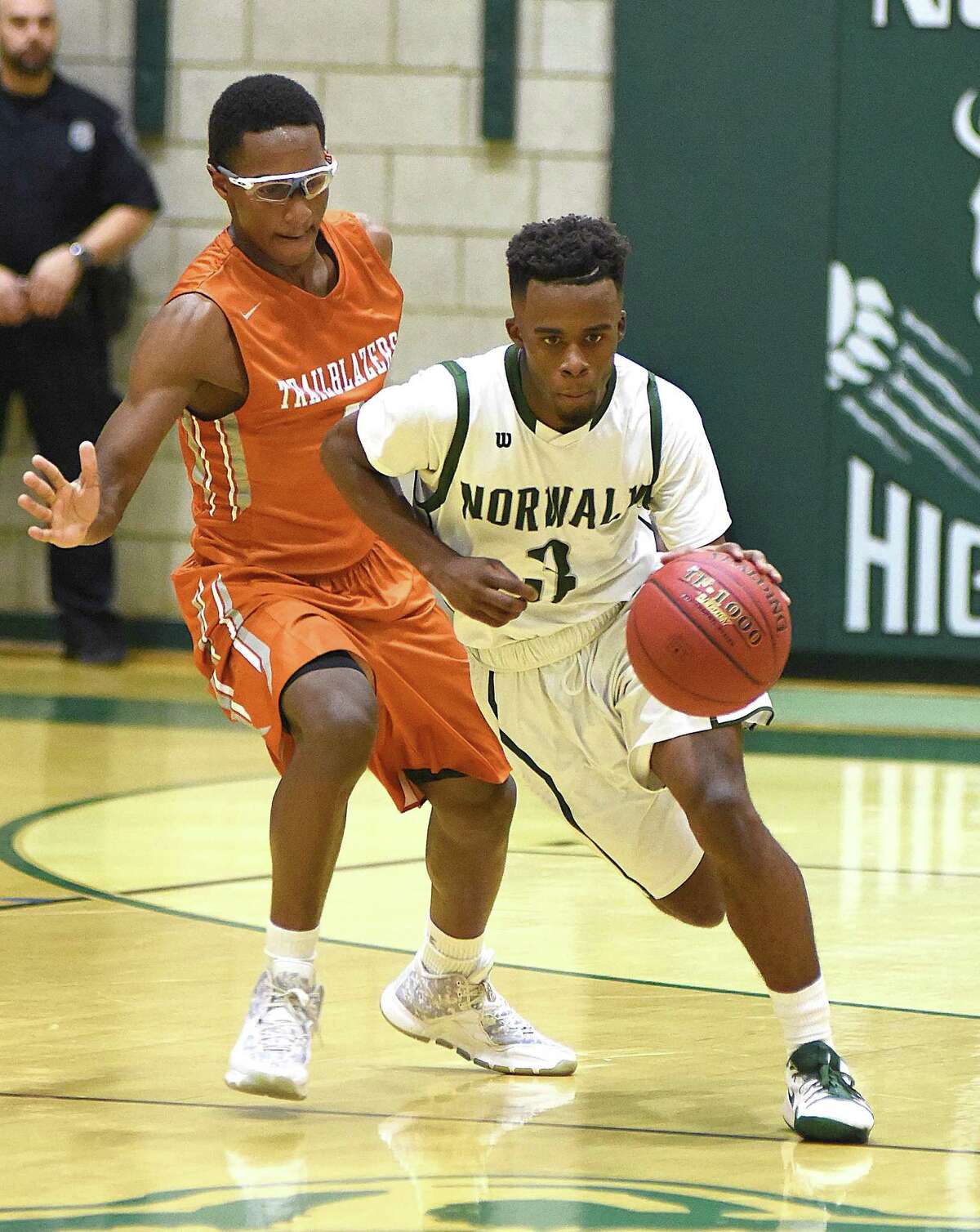 Norwalk’s Kerry Alcena, right, races past Capital Prep’s Roderick Henderson during Tuesday’s game.
