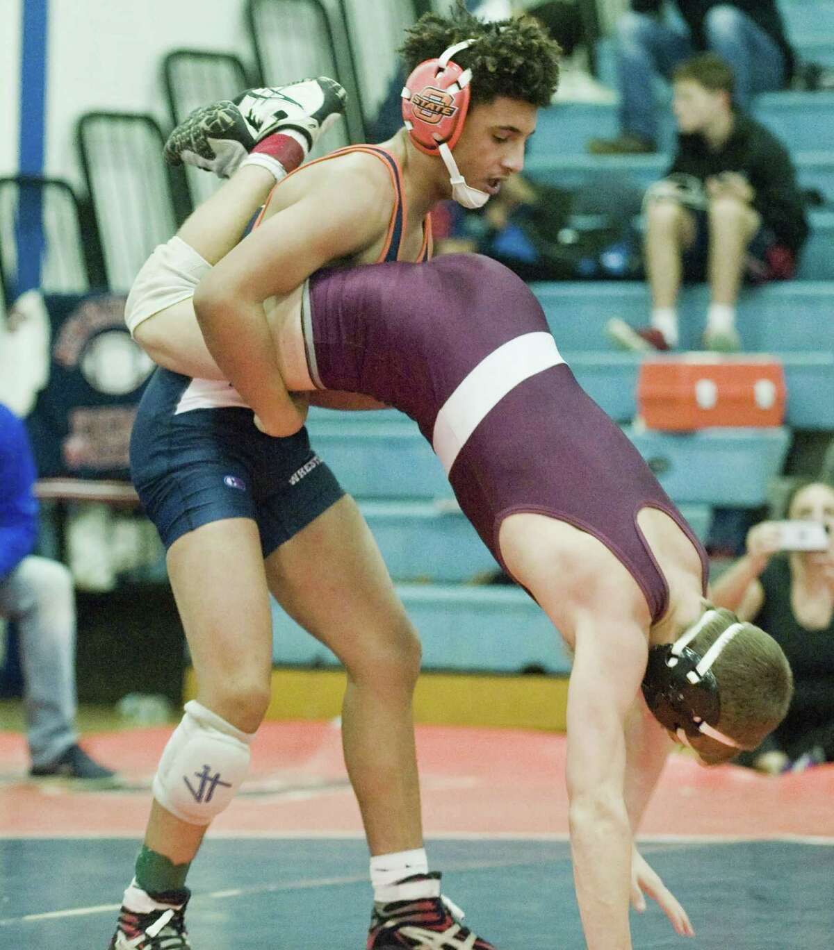 Danbury High School's Javon Priar dumps Kings Park High School's Chris Byrne in the 132 lb. class in a wrestling tournament at Danbury. Tuesday, Dec. 27, 2016