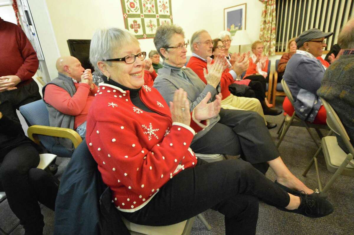 Hilltop Homes residents and guests, including Petrea Poler, enjoy a holiday concert from the Brien Mcmahon High School choir on Monday, Dec. 12, in Norwalk.