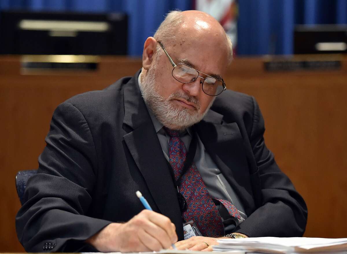 California Public Utilities Commissioner Mike Florio writes during a hearing at the California Public Utilities office in San Francisco on August 11, 2015. The CPUC is considering tougher rules for back-channel talks with utilities like PG&E in spite of the fact that they are being overseen by Florio, one of PG&E's main figureheads. (JOSH EDELSON/SPECIAL TO THE CHRONICLE)