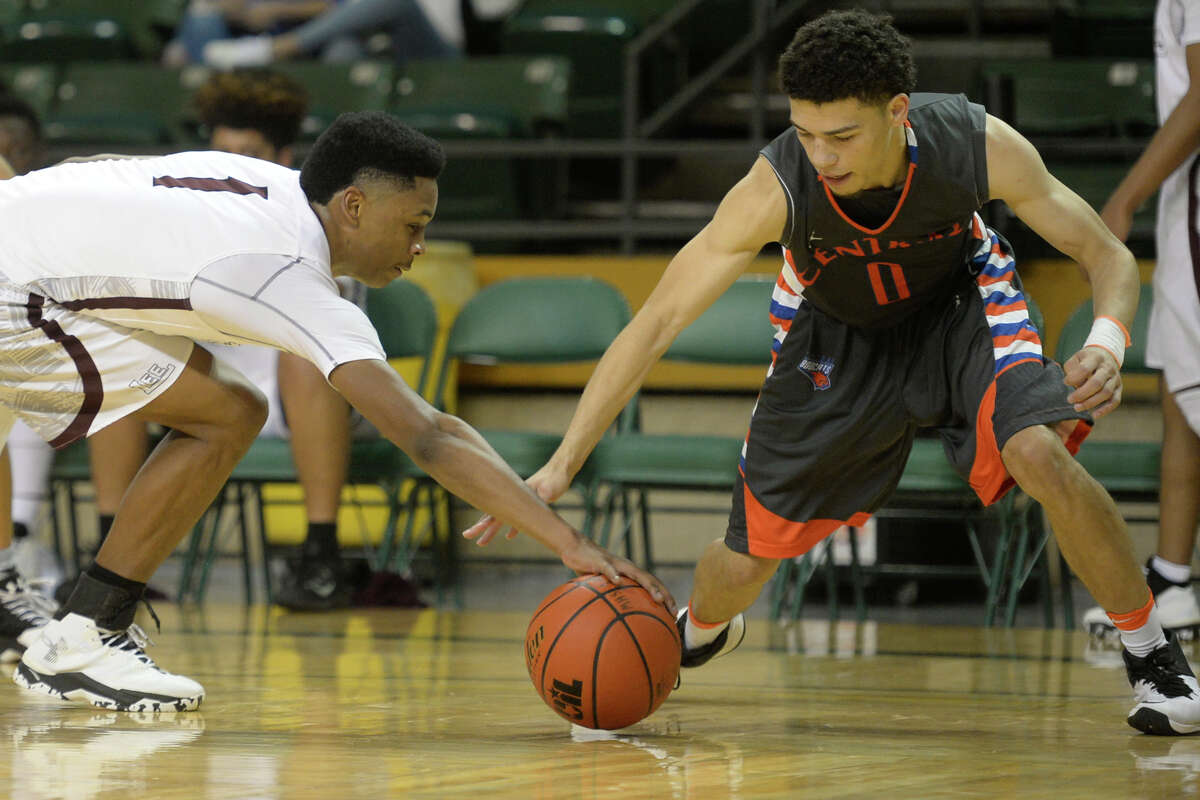 Lee's Sema'J Davis (1) and San Angelo Central's Isaiah Oliver (0) go after a loose ball during the first round of the Byron Johnston Holiday Classic on Wednesday, Dec. 28, 2016, at Chaparral Center. James Durbin/Reporter-Telegram