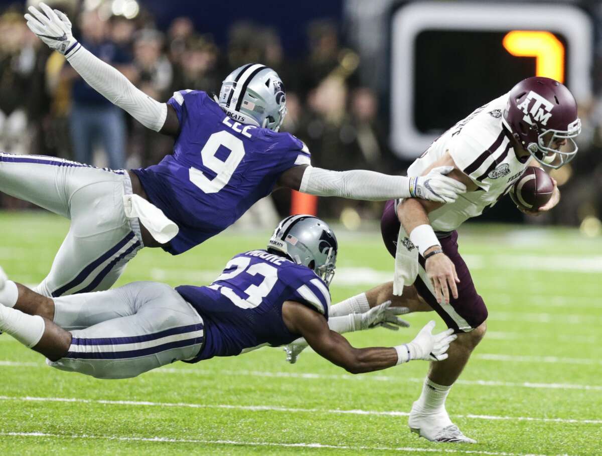 Texas A&M quarterback Trevor Knight (8) is scrambles out of the pocket as he is chased down by Kansas State linebacker Elijah Lee (9) and defensive back Cre Moore (23) during the second quarter of the Advocare V100 Texas Bowl at NRG Stadium on Wednesday, Dec. 28, 2016, in Houston. ( Brett Coomer / Houston Chronicle )