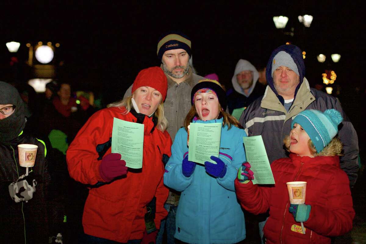Attendees of the annual Carol Sing in New Milford, in front, from left to right, Gabriel Wilkins, 11, Kristin Wilkins and Isabel Wilkins, 9, of Kent, and Skylar Holick, 7, of New Milford, and in back, Billy Wilkins and Trever Holick sing "O Little Town of Bethlehem" during the festivities held on the Village Green Dec. 19.