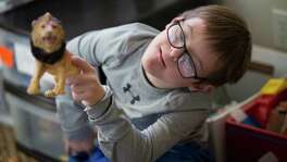 Sam Bullion, 10, plays with animal toy figures at his home in Austin, Thursday, Dec. 15, 2016. Playing with animal toy figures is Sam's favorite game. Bullion was born with Down syndrome and has been a struggle for his mother to get the Austin Independent School District to provide special education to his son.