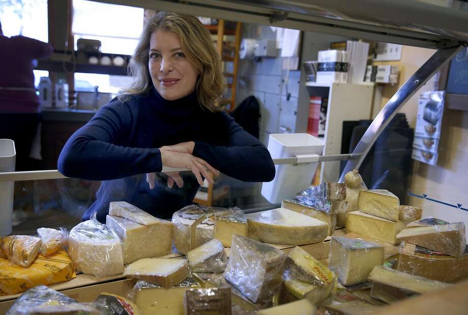 Nina Teicholz, above, at the cheese counter at the Cheese Board Collective in Berkeley, is the author of “The Big Fat Surprise,” which concludes that saturated fats, including cheese, left, actually lead to better health. Photo: Paul Chinn, The Chronicle