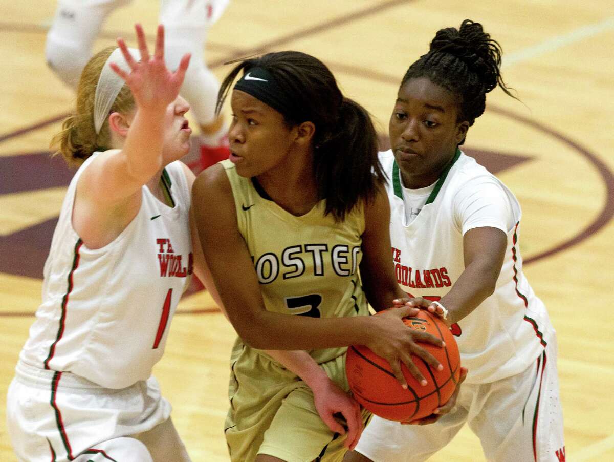 Foster guard Micayla Hamilton (3) is double teamed by The Woodlands forward Emma Warnsman (14) and guard Miima Mpagi (25) during the fourth quarter of a high school girls basketball game at the Magnolia Holiday Hoop Fest Thursday, Dec. 29, 2016, in Magnolia. The Woodlands defeated Foster 60-37 in the semifinals of the golf bracket to advance to FridayÂs final at noon.