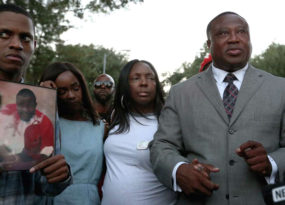 Quanell X, right, leader of the New Black Panther Nation, accompanies Casey Brown's family to seek justice for Brown Sunday, Oct. 16, 2016, in Houston. Brown is the shooting victim, and still in critical condition, of an off-duty police officer over a dog dispute. Center is Brown's mother Princess Coleman.