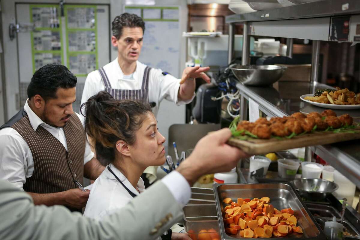 (left to right) David Baltodano, Calvin Pafford, and Myrhissa Bautista are busy in the kitchen during dinner service at Bluestem on Tuesday, November 22, 2016 in San Francisco, Calif.