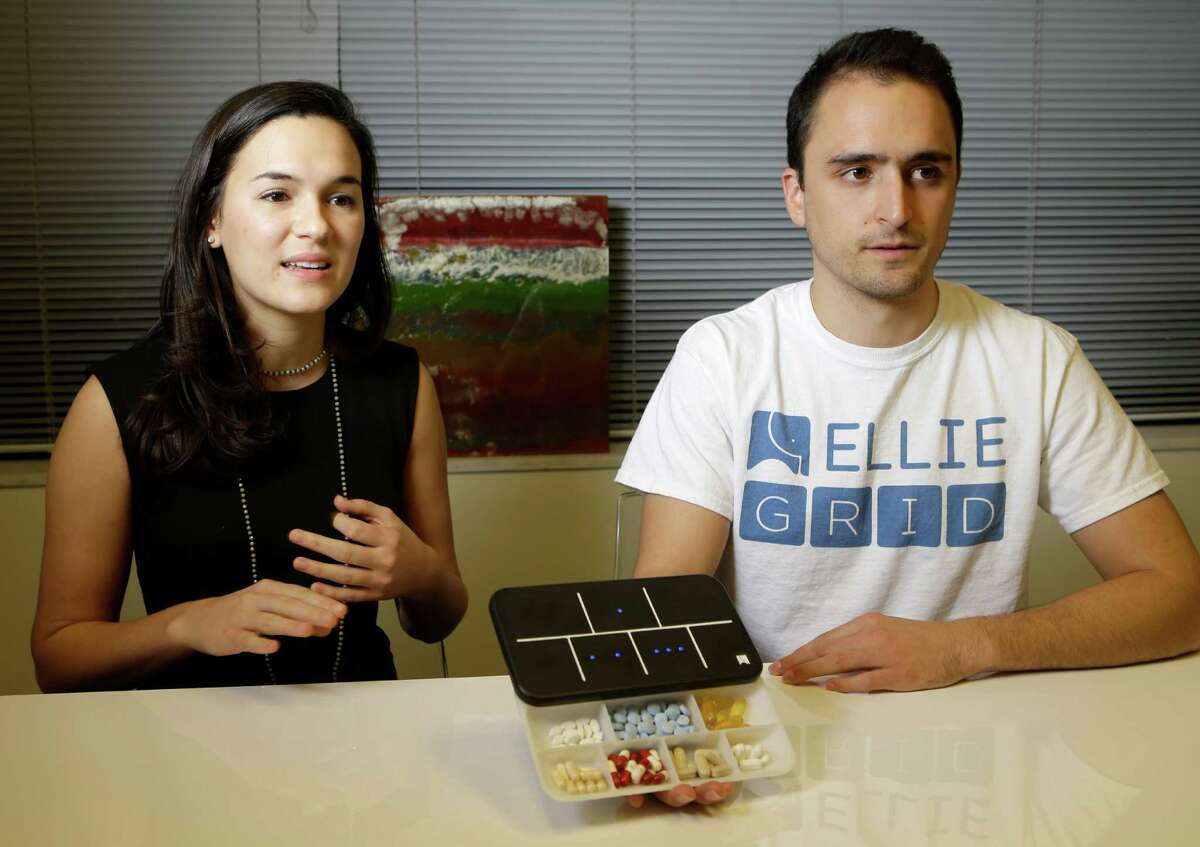 Regina Vatterott, left, and Abe Matamoros, right, talk about the prototype of Ellie Grid, a smart pillbox, which was designed to make taking pills and organizing them more efficient shown Thursday, Dec. 1, 2016, in Houston. ( Melissa Phillip / Houston Chronicle )
