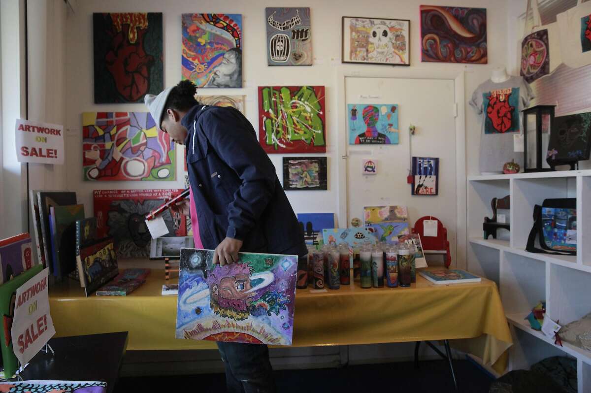 Sean McCready holds a piece of art he created while looking through the artwork for sale at their office in Berkeley, California, on Friday December 30, 2016. Sally Hindman and the Youth Spirit Artworks nonprofit she runs will be taking over the Street Spirit homeless newspaper on January 1st. The paper has been in existence for 22 years, and the youth organization's involvement will infuse a youthful new look to the publication.