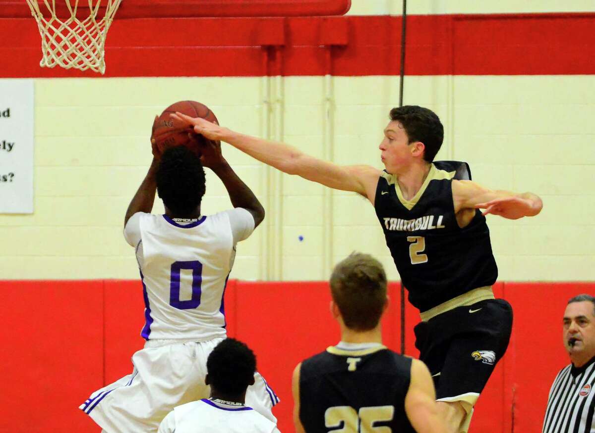 Trumbull's John Lynch blocks a shot attempt by Westhill's C.J. Brown during the final round of Merit Insurance Classic boys basketball tournament action in Stratford, Conn., on Friday Dec. 30, 2016.