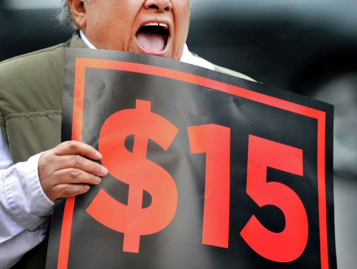 Ivette Alfonso, president of the state-wide board of Citizen Action of New York, yells out in support of the $15 minimum wage during a rally outside the offices of the Business Council of New York State on Thursday, March 24, 2016, in Albany, N.Y. (Paul Buckowski / Times Union)