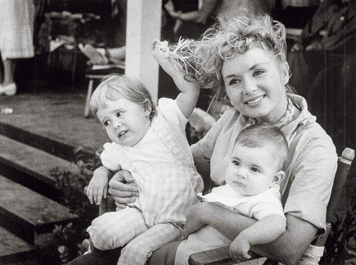 Debbie Reynolds, the beloved movie queen who held her head high under very public marital scandal, with little ones Carrie and Todd Fisher.