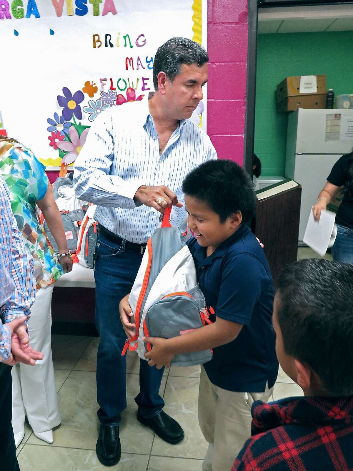 In this file photo, Larga Vista Kids Cafe after-school meal program participant Raul Vitela is presented with a backpack filled with the non-perishable food items given to the South Texas Food Bank by local businessman Hugo Flores at the Larga Vista Community Center.