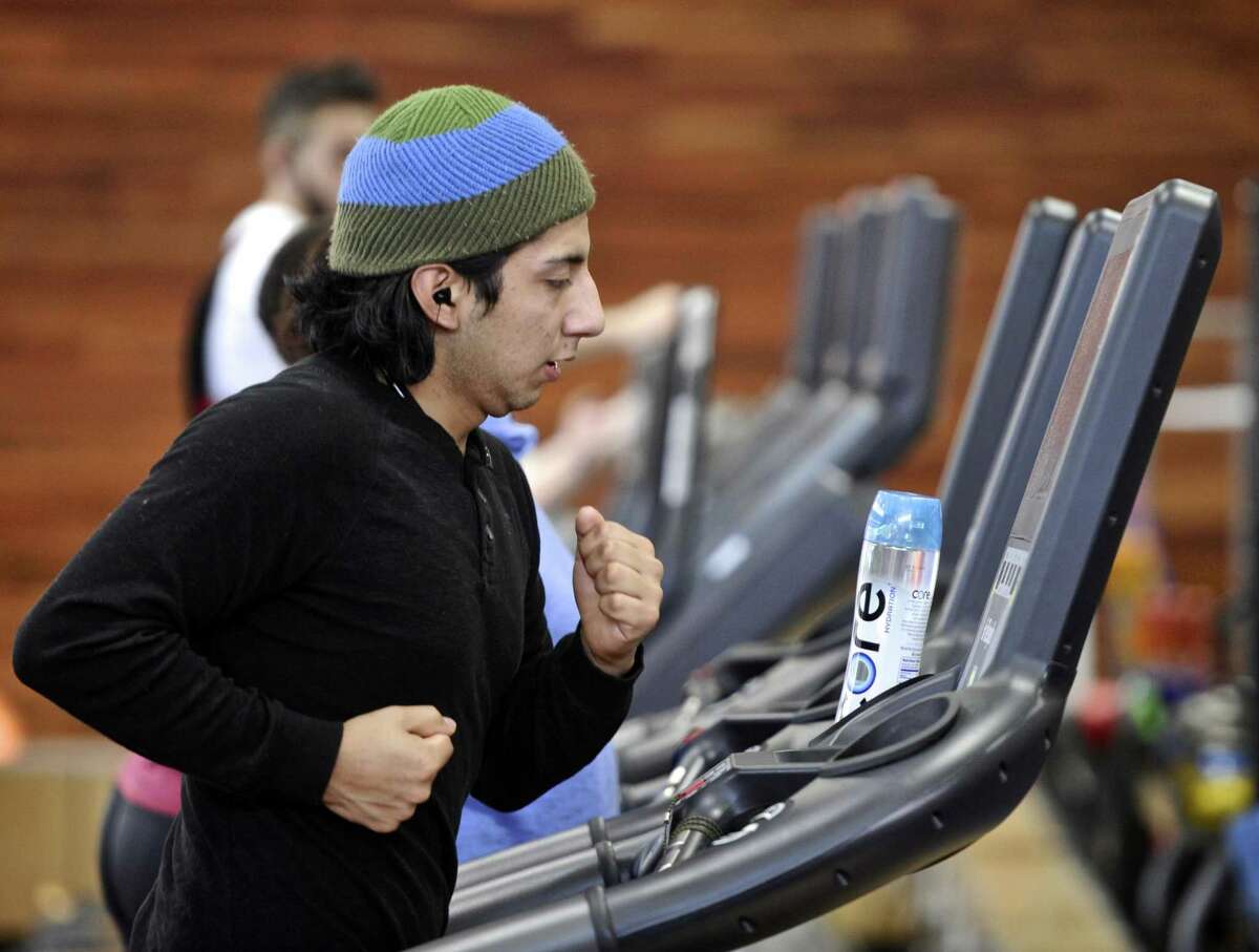 Leonardo Billa, of Danbury, runs on a treadmill at The Edge Fitness Club on New Years Day, January 1, 2017, in Danbury, Conn.