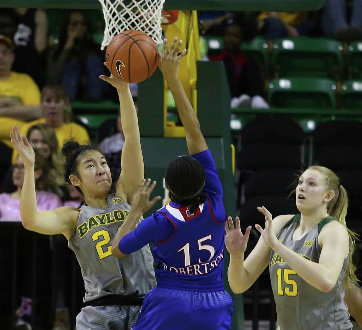 Baylor guard Natalie Chou (24) blocks the shot of Kansas guard Aisia Robertson in the second half of the third-ranked Lady Bears' 90-43 victory Sunday.