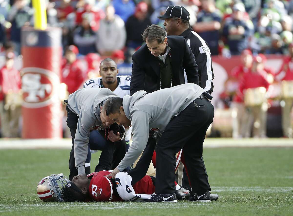 San Francisco 49ers cornerback Rashard Robinson (33) is tended to by trainers after being injured during the first half of an NFL football game against the Seattle Seahawks in Santa Clara, Calif., Sunday, Jan. 1, 2017. (AP Photo/Tony Avelar)