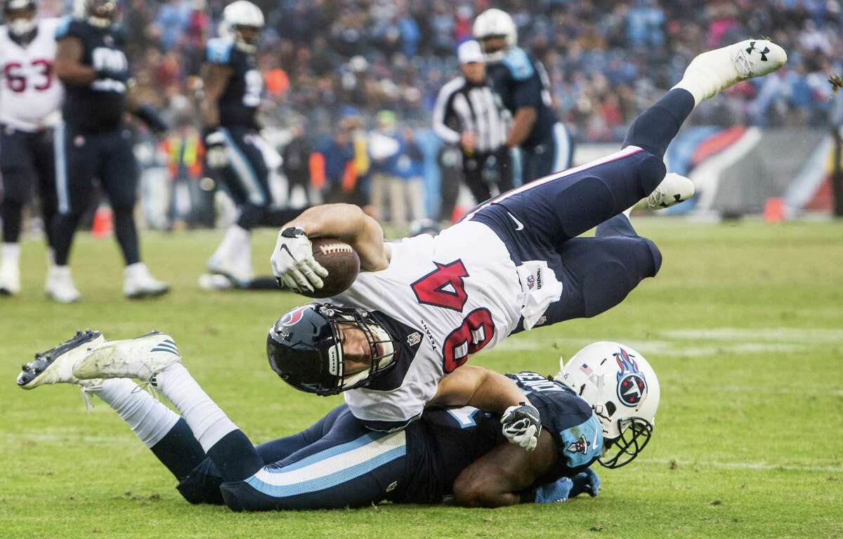 Texans tight end Ryan Griffin (84) is upended by Titans strong safety Da'Norris Searcy short of a first down during the fourth quarter Sunday. Griffin had two catches for 10 yards.