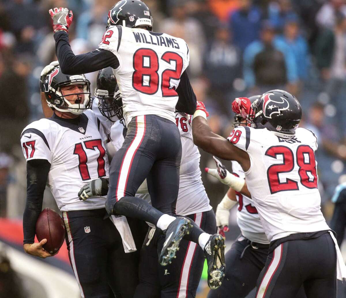 Texans QB Brock Osweiler (17) doesn't mind a little contact with teammates after scoring on a 1-yard run in Sunday's regular-season finale at Tennessee. The Texans can also celebrate the NFL's No. 1 defense heading into the postseason.